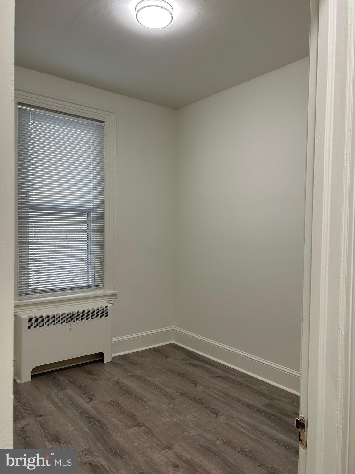 206 West Gay Street, Unit 1 West Chester, PA 19380 - Photo 7 of 14 a view of an empty room with wooden floor and a window
