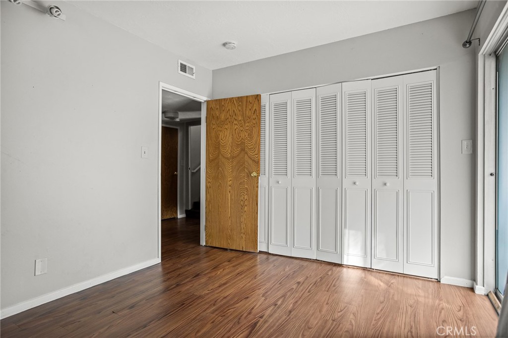 966 Willow Creek Road, Unit 9 Lake Arrowhead, CA 92352 - Photo 18 of 24 a view of an empty room with wooden floor