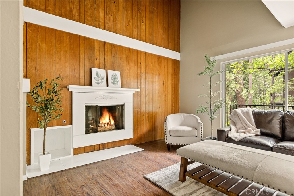 966 Willow Creek Road, Unit 9 Lake Arrowhead, CA 92352 - Photo 2 of 27 a living room with furniture and a fireplace