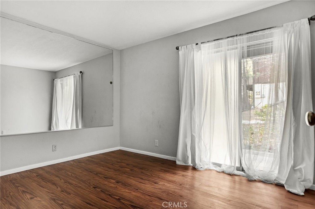 966 Willow Creek Road, Unit 9 Lake Arrowhead, CA 92352 - Photo 21 of 24 a view of wooden floor and windows in a room