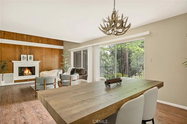 a dining room with furniture a fireplace and wooden floor