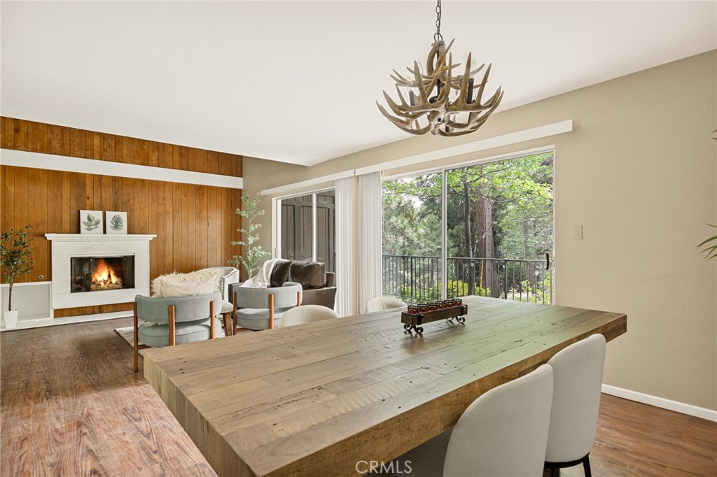 966 Willow Creek Road, Unit 9 Lake Arrowhead, CA 92352 - Photo 6 of 27 a dining room with furniture a fireplace and wooden floor