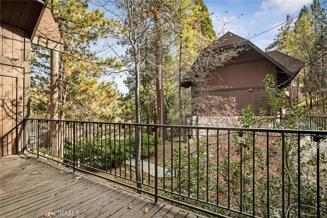 a view of a balcony with wooden floor and fence