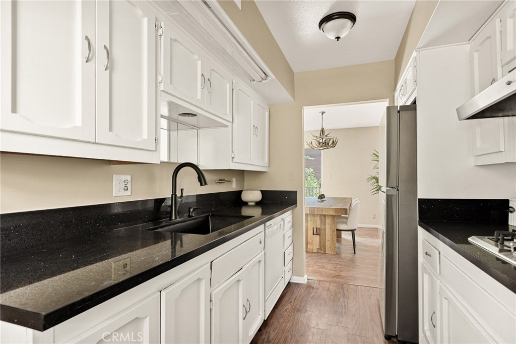 966 Willow Creek Road, Unit 9 Lake Arrowhead, CA 92352 - Photo 8 of 24 a kitchen with granite countertop a sink stainless steel appliances and cabinets