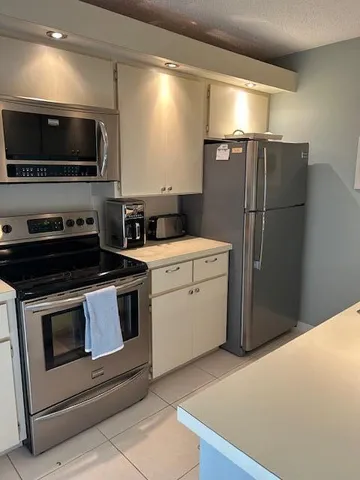 a kitchen with a refrigerator stove and microwave