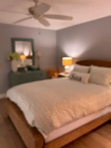 a bedroom with a bed and a lamp
