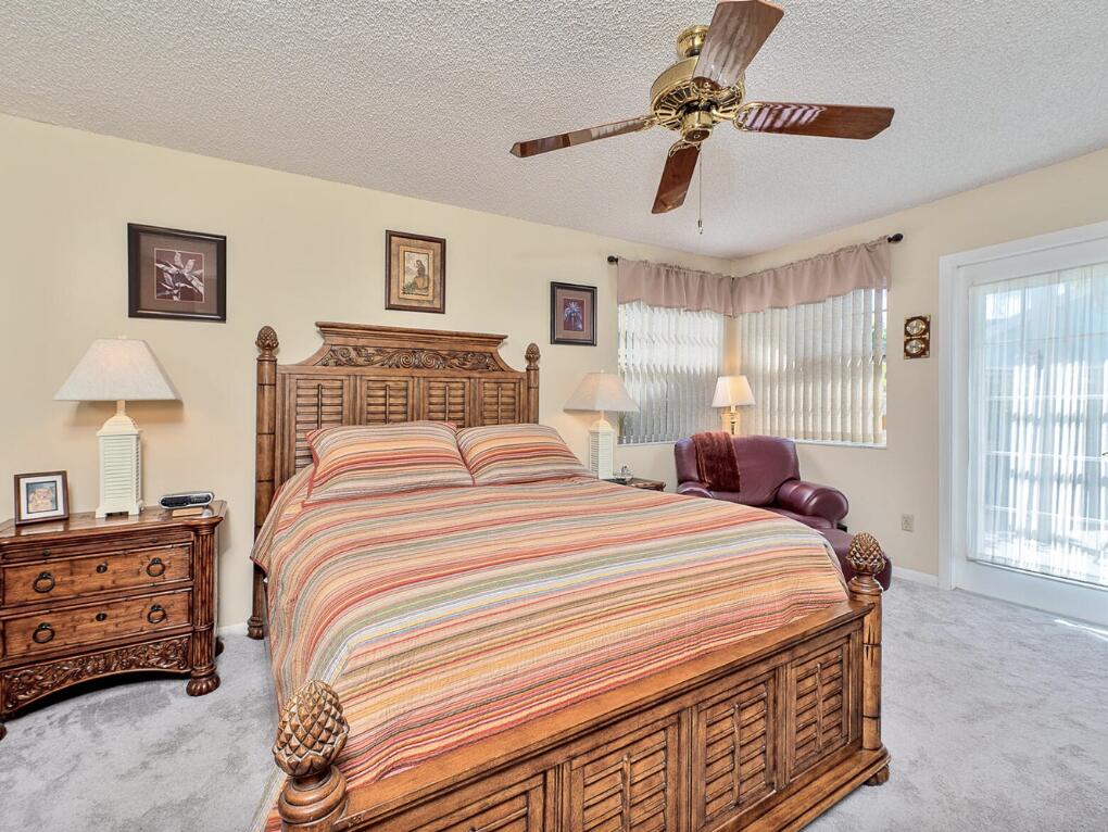 5124 Point Alexis Boca Raton, FL 33431 - Photo 11 of 21 a bedroom with a bed and a chandelier