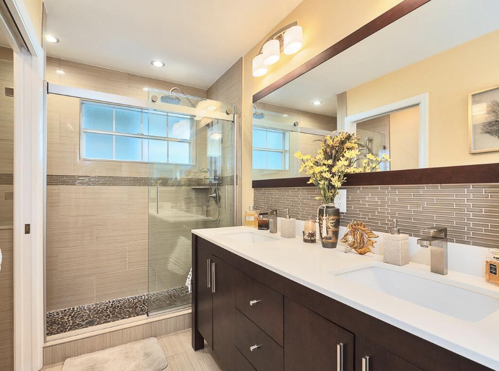5124 Point Alexis Boca Raton, FL 33431 - Photo 12 of 21 a bathroom with a double vanity sink mirror and shower