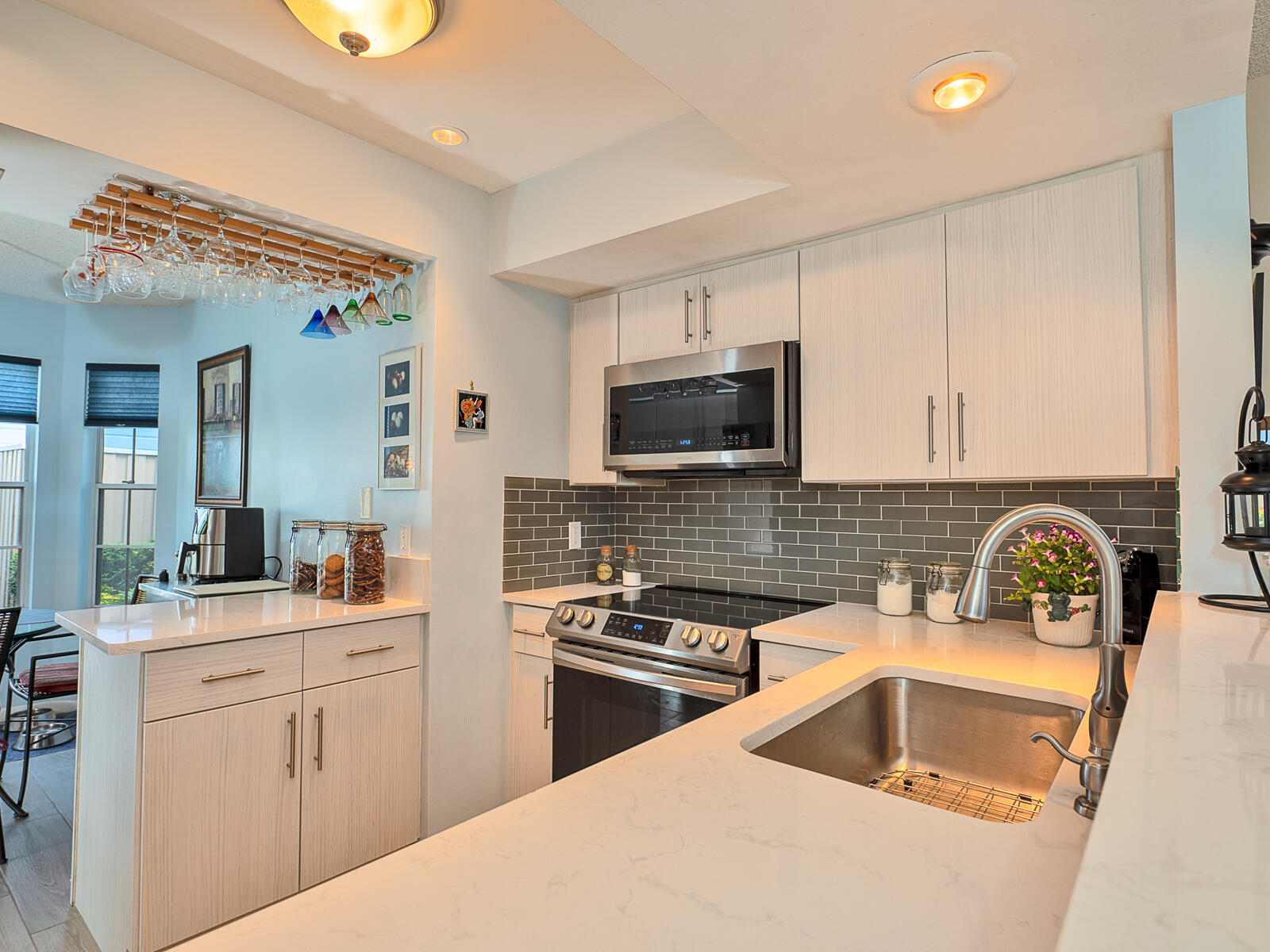 5124 Point Alexis Boca Raton, FL 33431 - Photo 5 of 21 a kitchen that has a sink and a stove in it