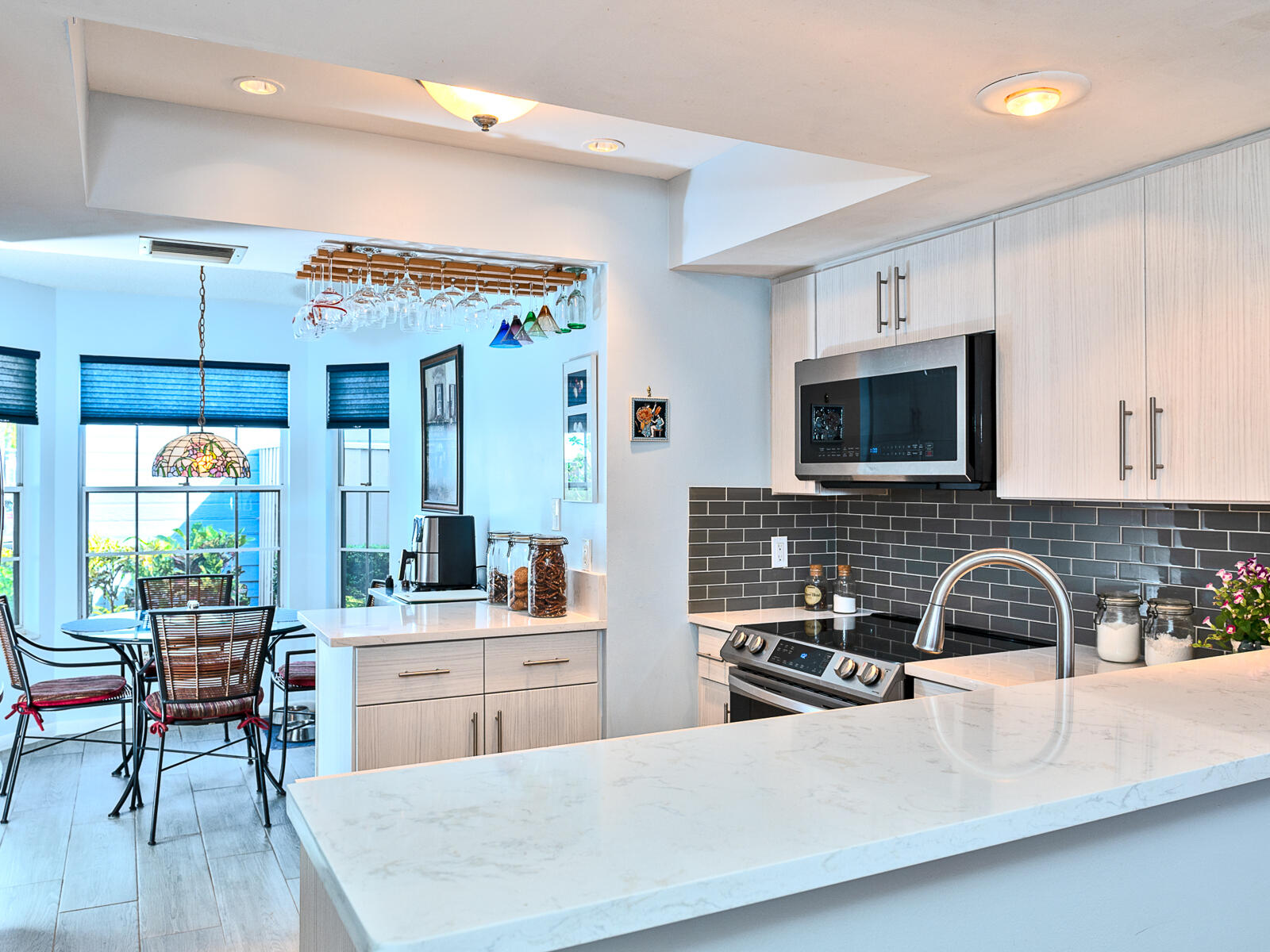 5124 Point Alexis Boca Raton, FL 33431 - Photo 7 of 21 a kitchen with stainless steel appliances a sink a stove a table and chairs