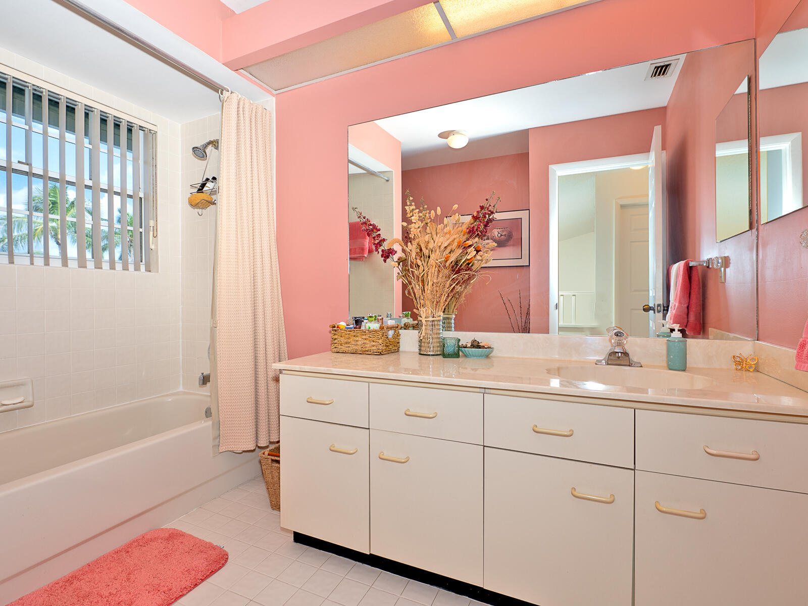 5124 Point Alexis Boca Raton, FL 33431 - Photo 9 of 21 a bathroom with a double vanity sink a mirror a bathtub and next to a window