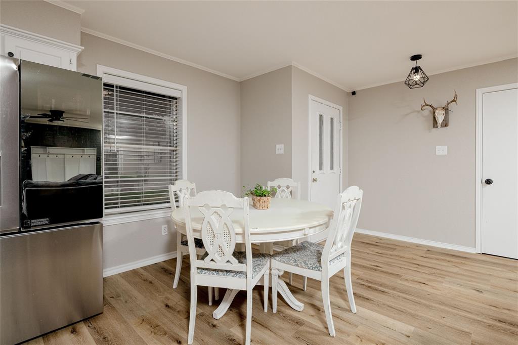117 Kathryn Street Sanger, TX 76266 - Photo 16 of 40 Dining space with ornamental molding and light wood-style floors
