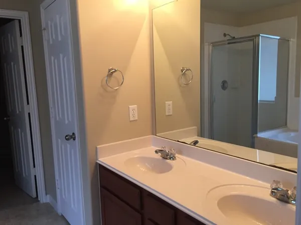 a bathroom with a sink vanity granite tub and shower