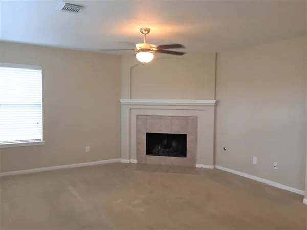 a view of empty room with a fireplace
