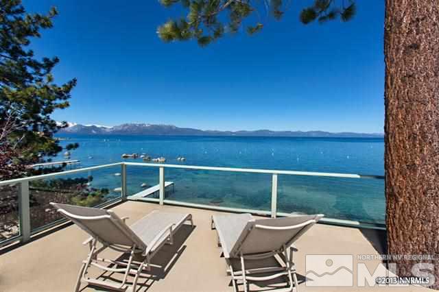 a balcony with table and chairs