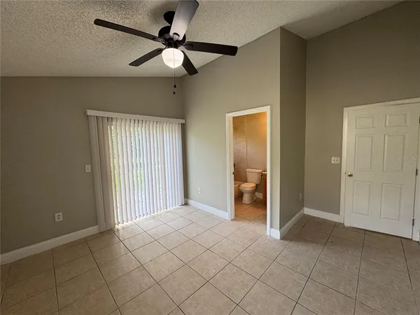 a view of a livingroom with a ceiling fan and window