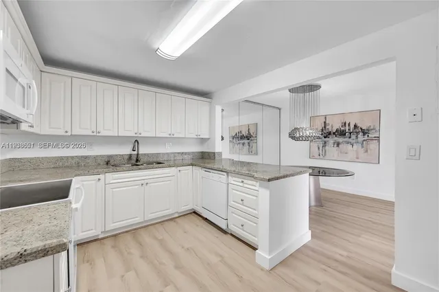 a kitchen with stainless steel appliances granite countertop a sink and cabinets