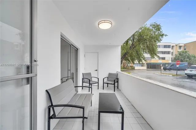 a dining room with furniture and a kitchen view