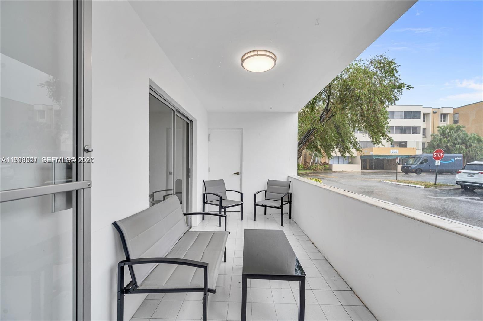 6861 Southwest 147th Avenue, Unit 1H Miami, FL 33193 - Photo 15 of 30 a dining room with furniture and a kitchen view