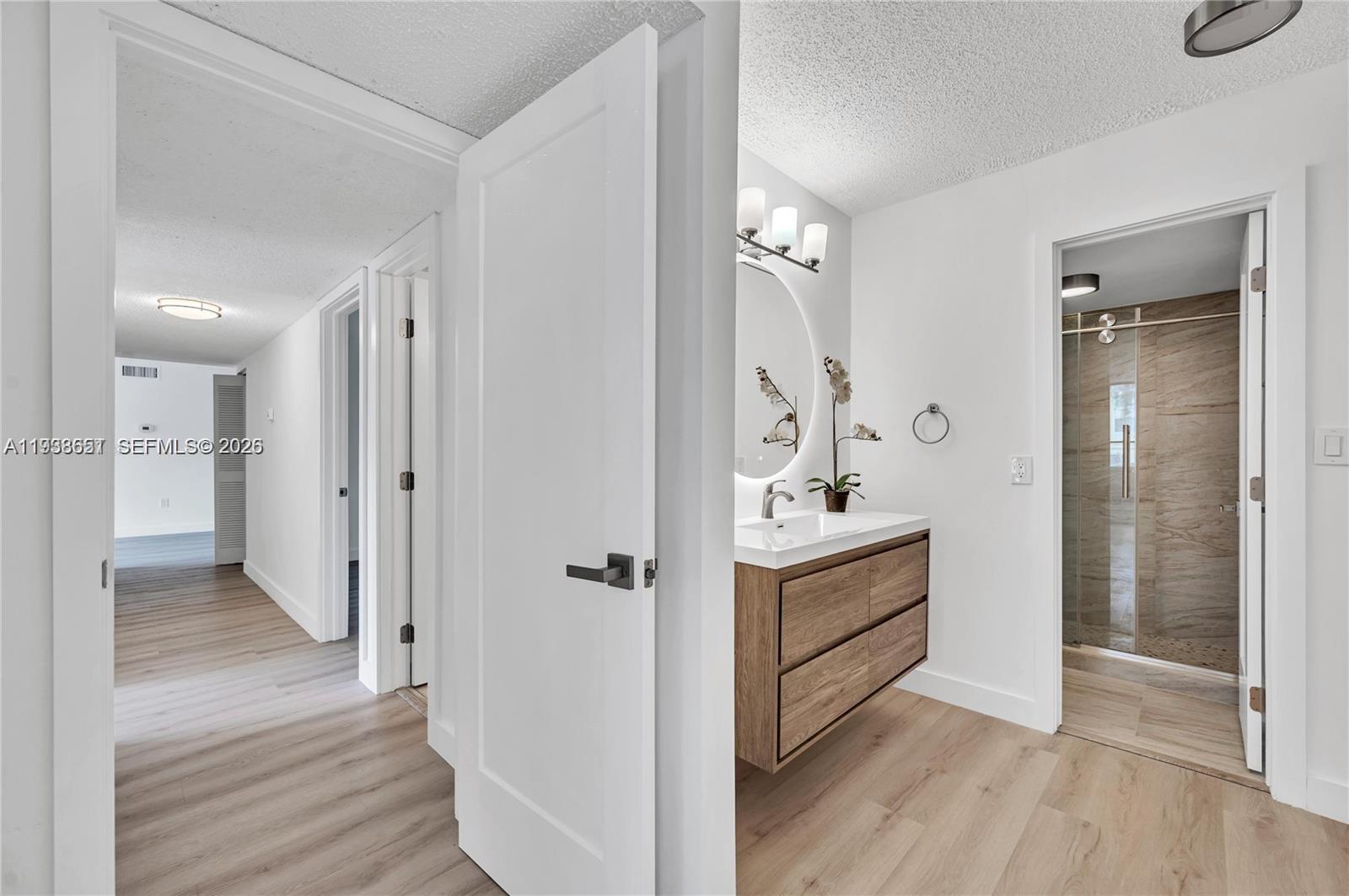 6861 Southwest 147th Avenue, Unit 1H Miami, FL 33193 - Photo 16 of 30 a bathroom with a sink and a mirror