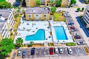 6861 Southwest 147th Avenue, Unit 1H Miami, FL 33193 - Photo 2 of 30 an aerial view of multiple houses with outdoor space