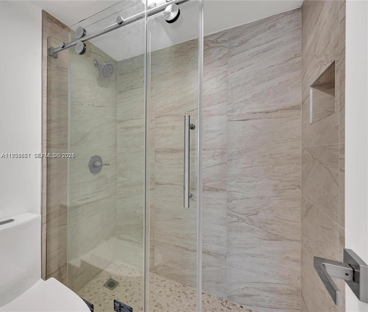 6861 Southwest 147th Avenue, Unit 1H Miami, FL 33193 - Photo 21 of 30 a bathroom with a shower and toilet