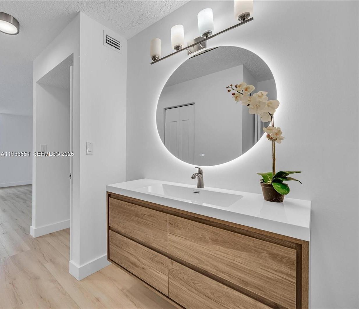 6861 Southwest 147th Avenue, Unit 1H Miami, FL 33193 - Photo 22 of 30 a bathroom with a sink and a mirror