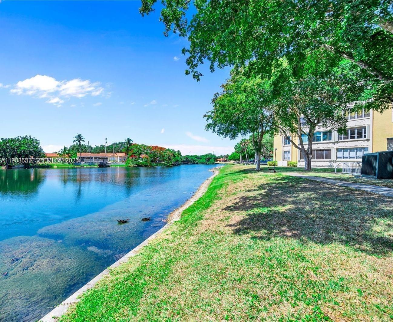 6861 Southwest 147th Avenue, Unit 1H Miami, FL 33193 - Photo 28 of 30 a view of a lake with houses in the back
