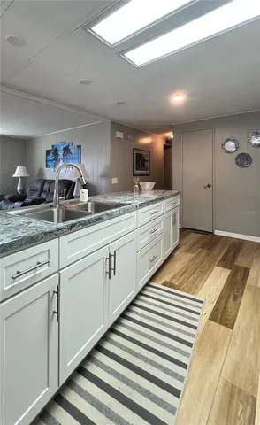 a living room with furniture a flat screen tv and a window