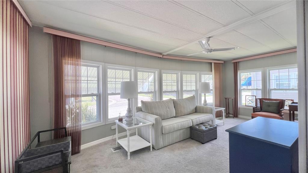 1100 South Belcher Road, Unit 657 Largo, FL 33771 - Photo 19 of 81 a living room with furniture and large windows