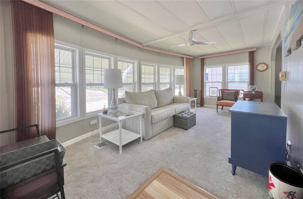 1100 South Belcher Road, Unit 657 Largo, FL 33771 - Photo 20 of 81 a living room with furniture and large windows