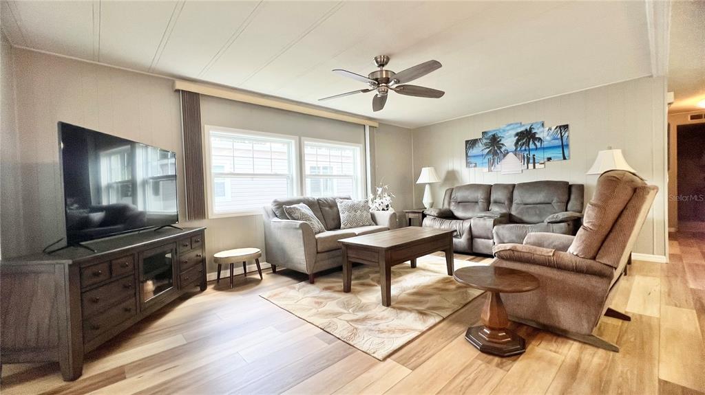 1100 South Belcher Road, Unit 657 Largo, FL 33771 - Photo 25 of 81 a living room with furniture a flat screen tv and a window