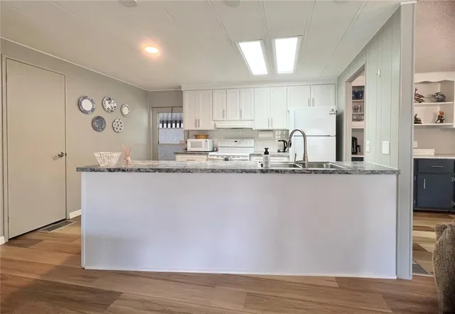 a bathroom with a granite countertop sink mirror and shower