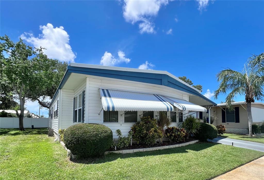 1100 South Belcher Road, Unit 657 Largo, FL 33771 - Photo 3 of 81 a view of a house with a yard and a garden