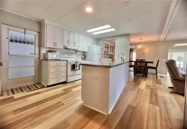 an aerial view of a house with a garden and lake view