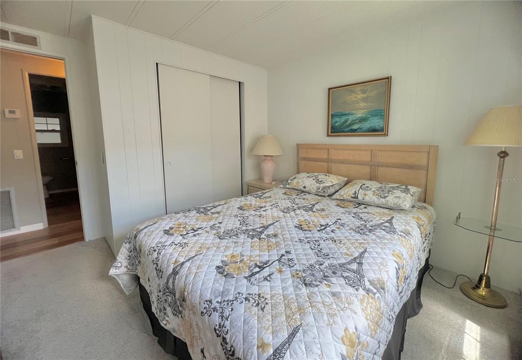 1100 South Belcher Road, Unit 657 Largo, FL 33771 - Photo 32 of 81 a bedroom with a bed and a painting on the wall
