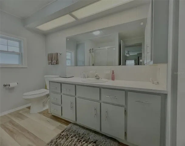 a view of a patio with a table and chairs under an umbrella
