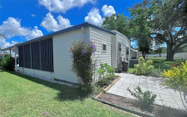 a backyard of a house with table and chairs