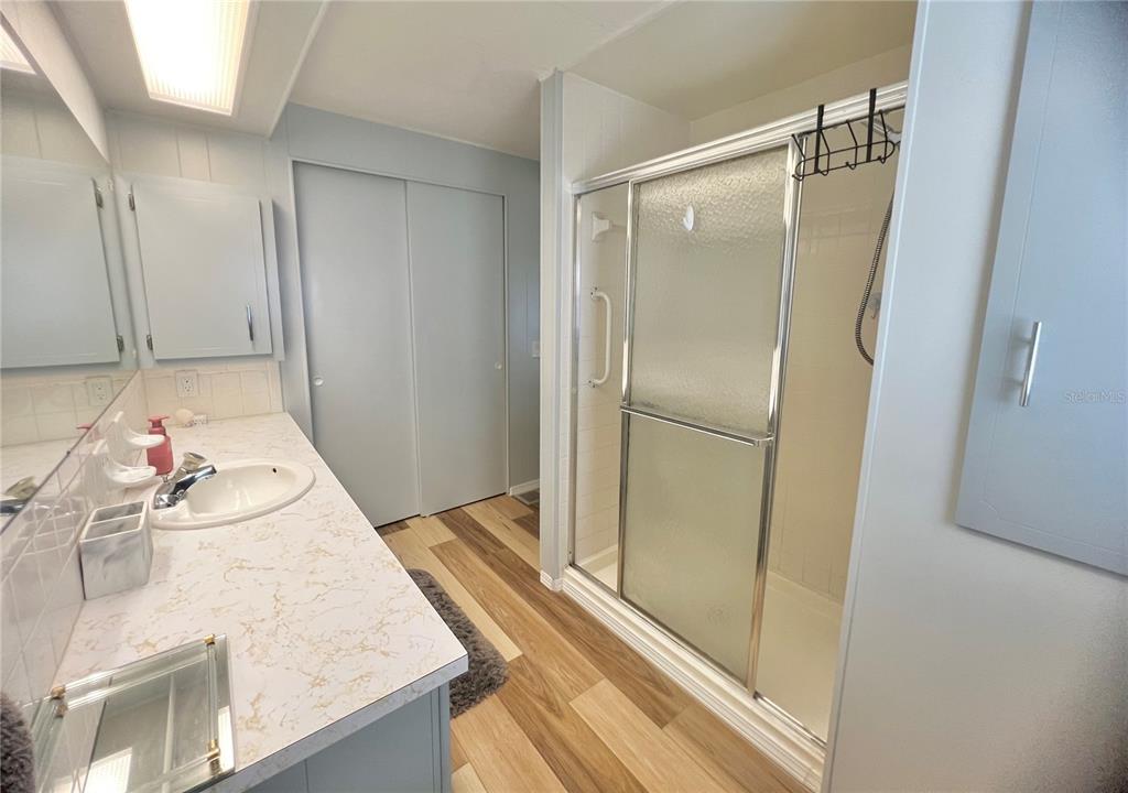 1100 South Belcher Road, Unit 657 Largo, FL 33771 - Photo 42 of 81 a bathroom with a granite countertop sink mirror and shower