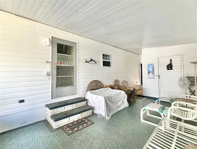 a living room with furniture and large windows