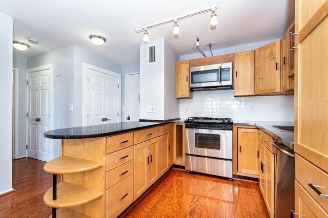 a kitchen with stainless steel appliances granite countertop a stove and a sink