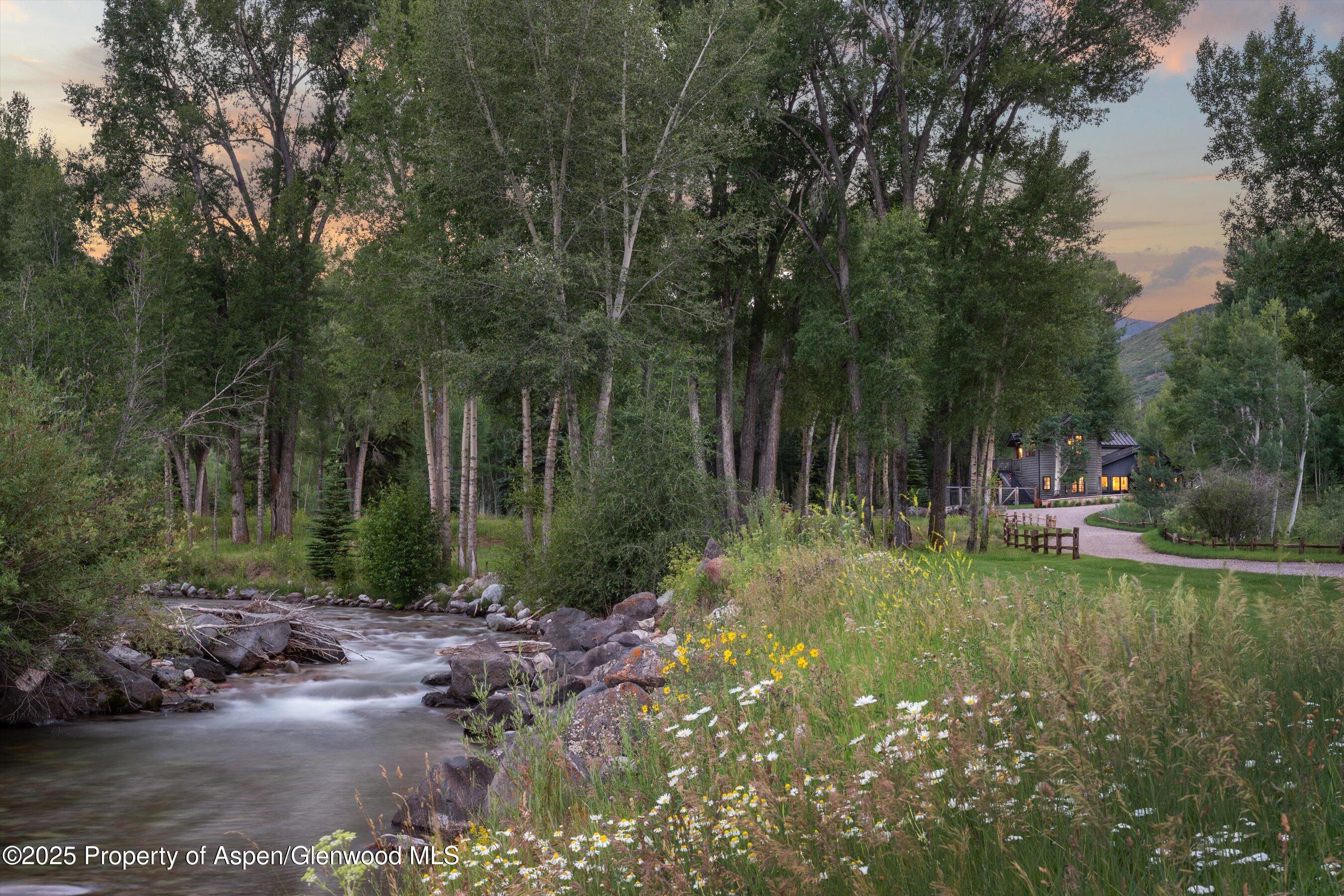 6458 Snowmass Creek Road Snowmass, CO 81654 - Photo 105 of 114 a backyard of a house with lots of green space and lake view
