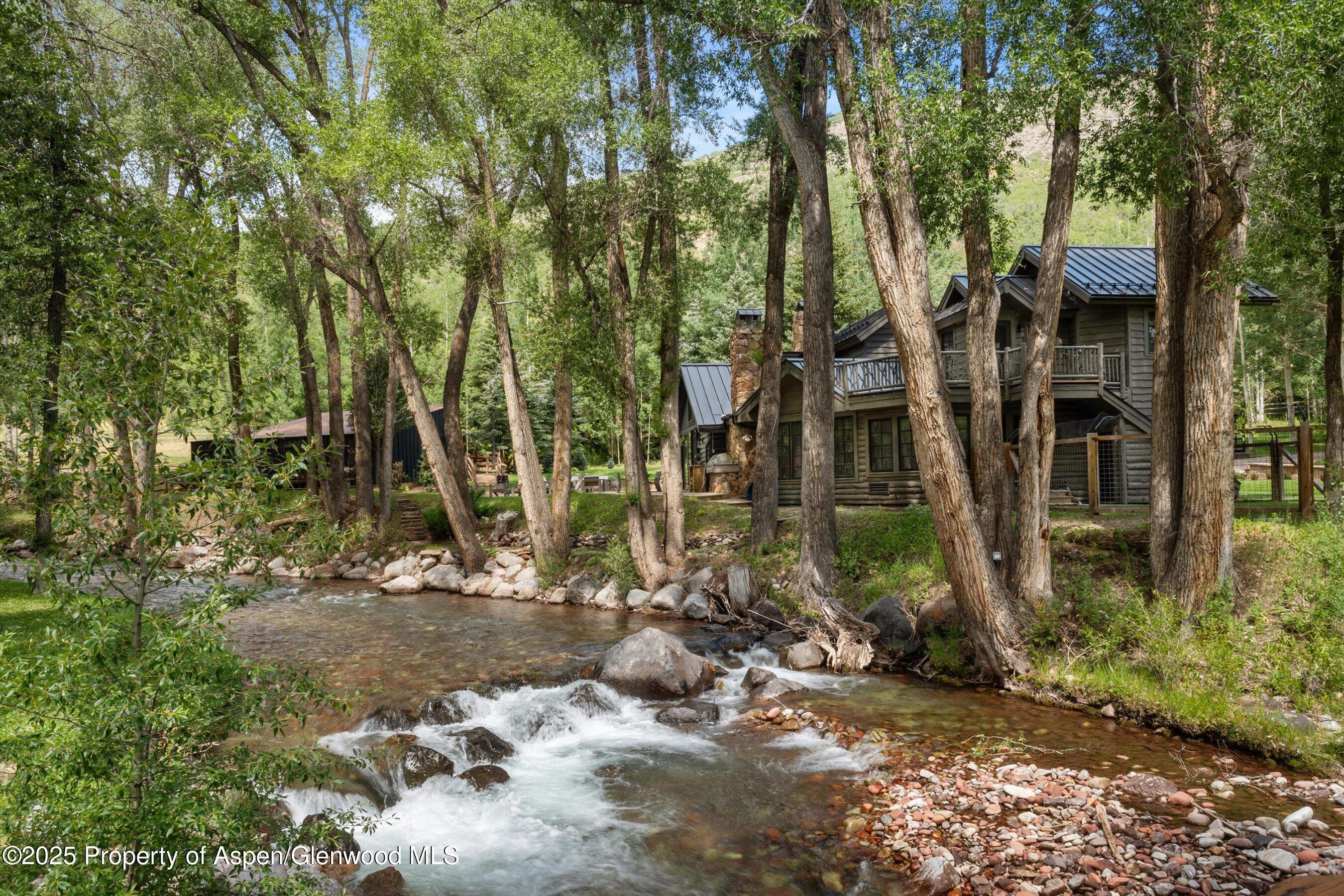 6458 Snowmass Creek Road Snowmass, CO 81654 - Photo 12 of 114 a backyard of a house with lots of green space
