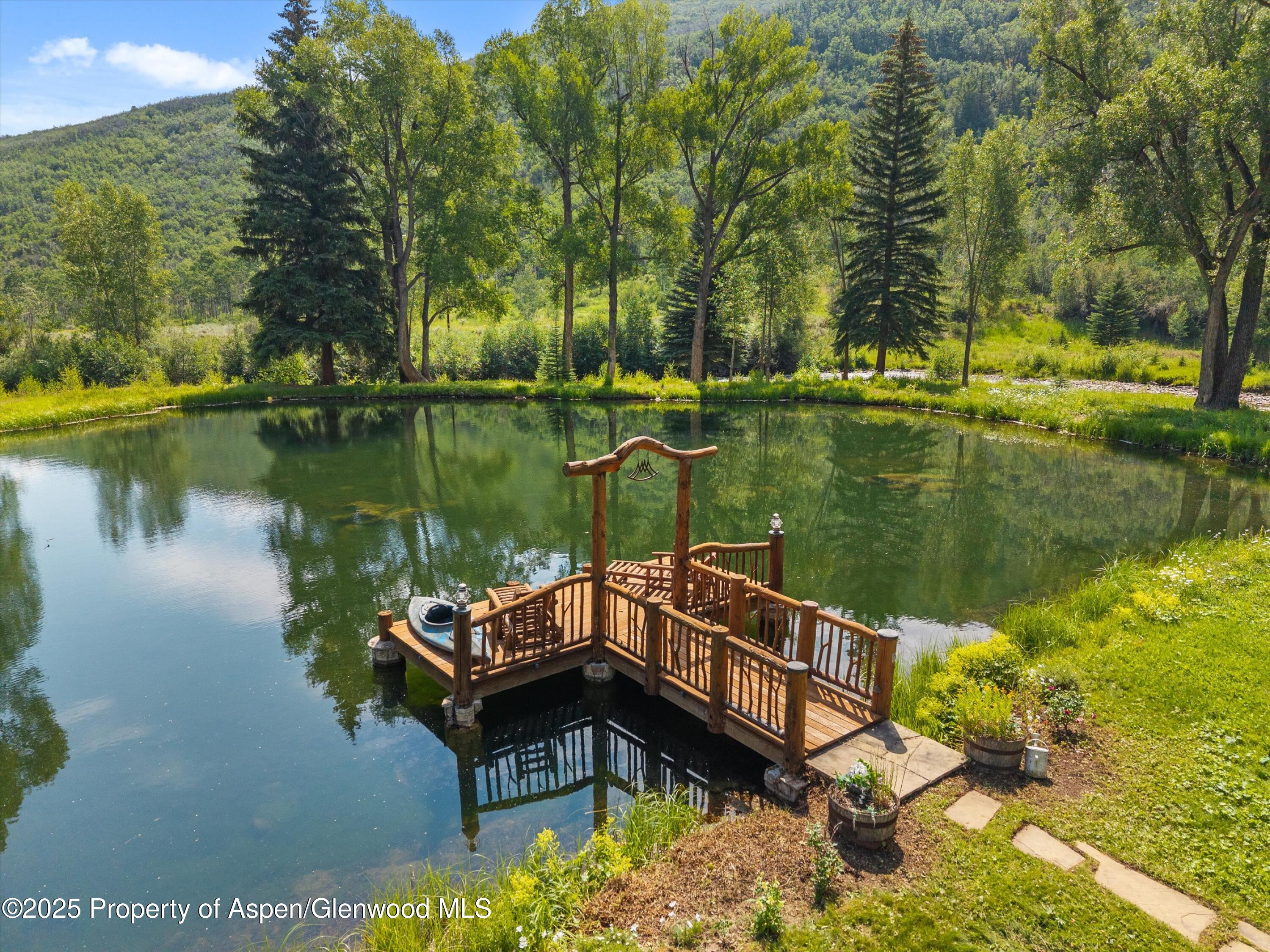 6458 Snowmass Creek Road Snowmass, CO 81654 - Photo 17 of 114 a lake view with a wooden fence and lake view