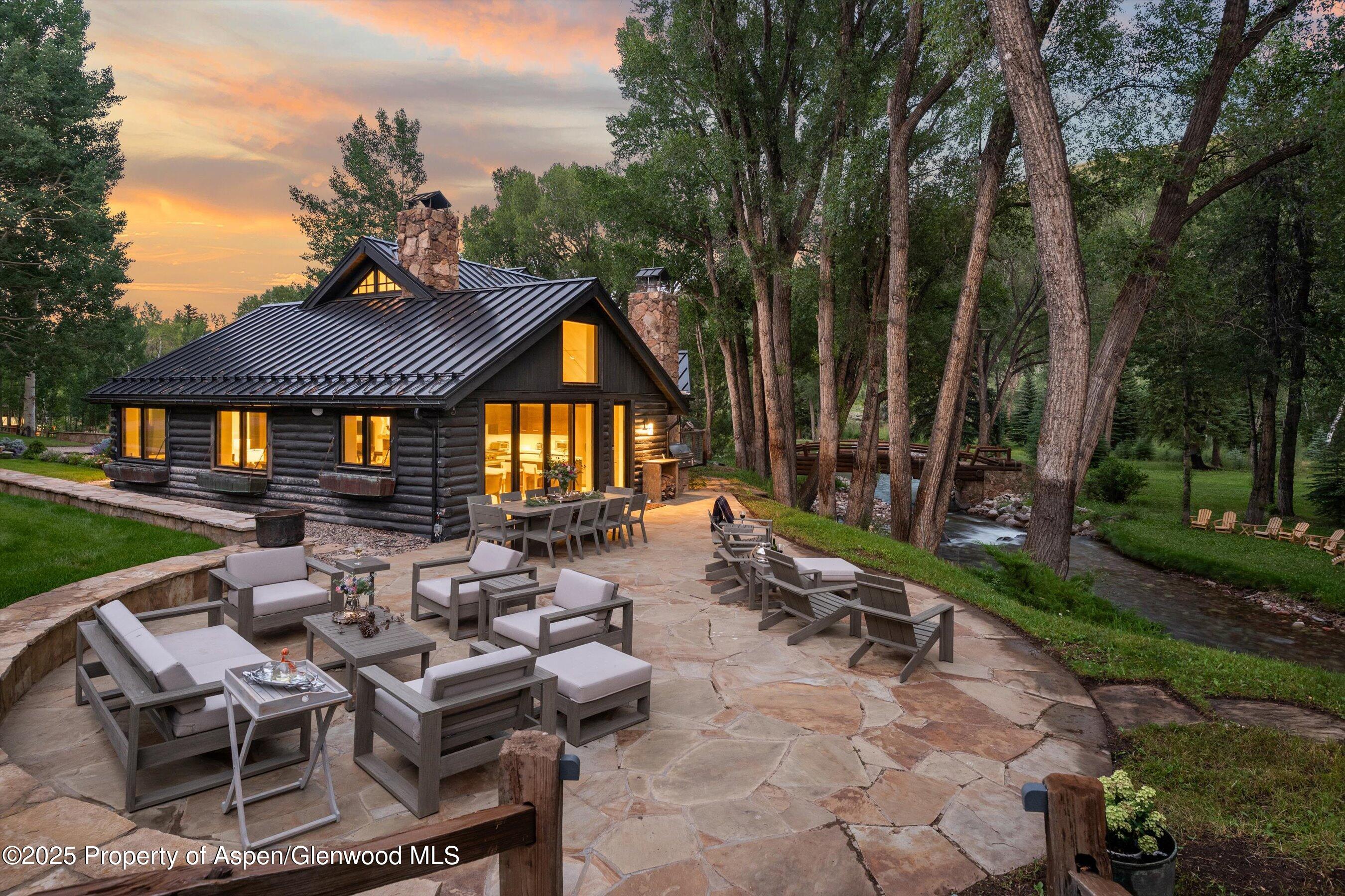 6458 Snowmass Creek Road Snowmass, CO 81654 - Photo 21 of 114 a view of a patio with table and chairs and potted plants