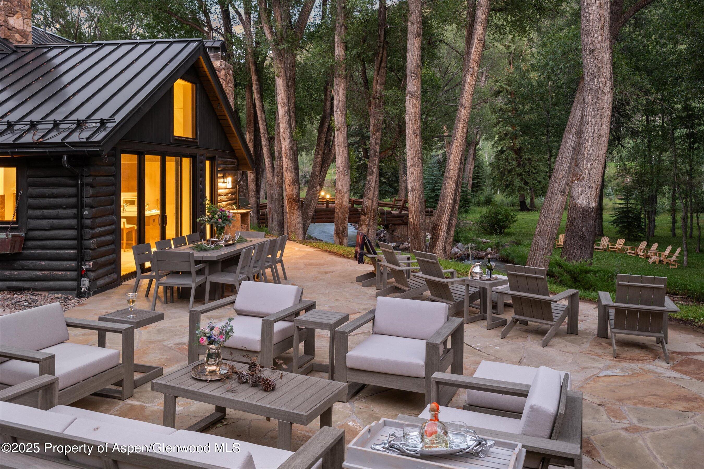 6458 Snowmass Creek Road Snowmass, CO 81654 - Photo 25 of 114 a view of a patio with couches table and chairs and potted plants