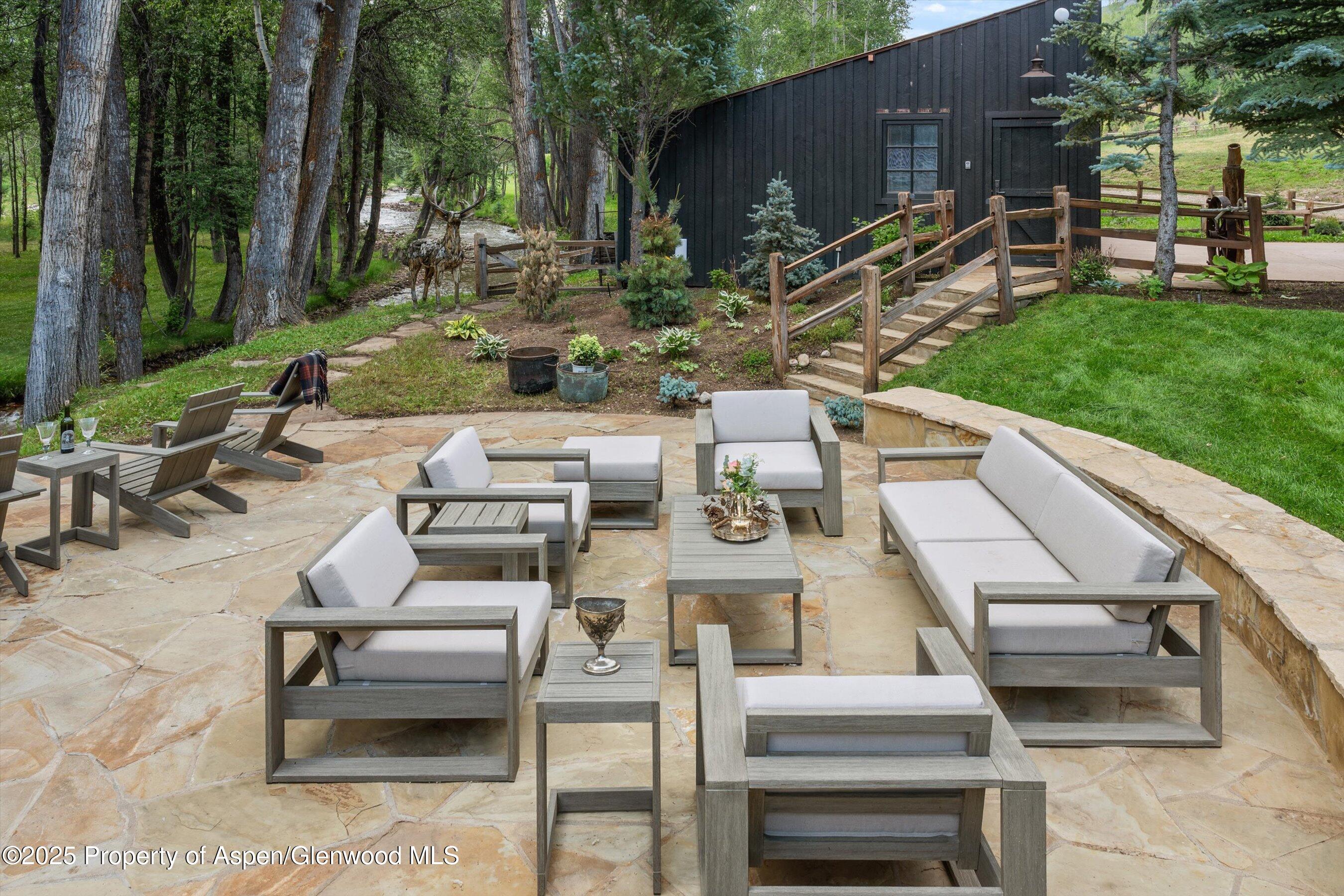 6458 Snowmass Creek Road Snowmass, CO 81654 - Photo 31 of 114 a view of a patio with table and chairs and potted plants