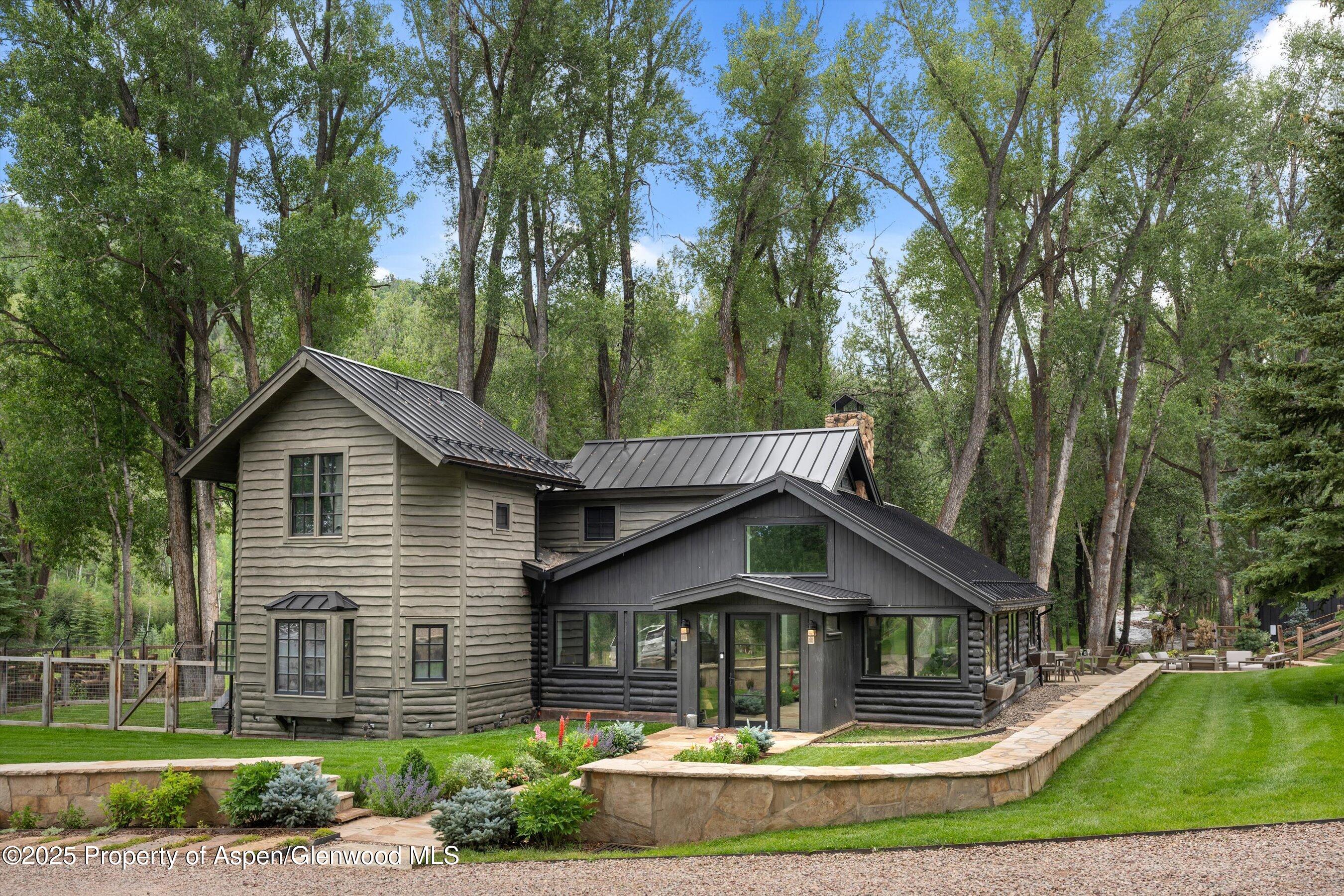 6458 Snowmass Creek Road Snowmass, CO 81654 - Photo 34 of 114 a front view of a house with garden