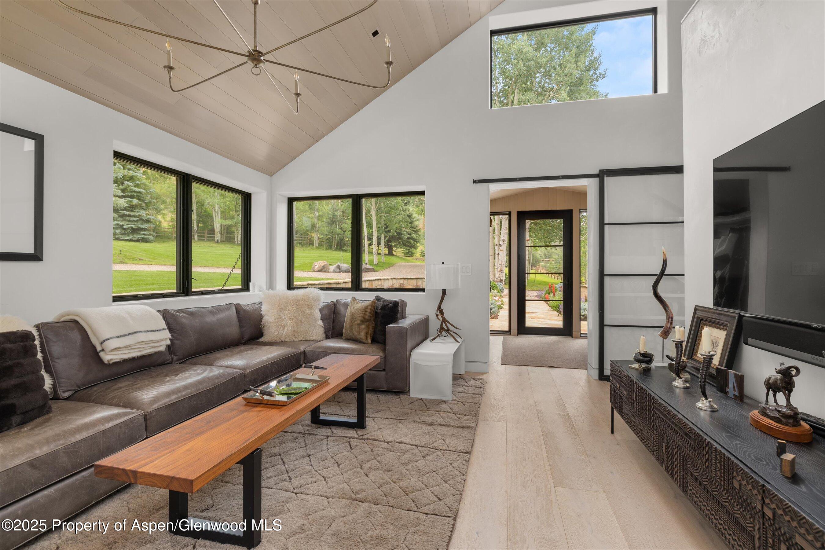 6458 Snowmass Creek Road Snowmass, CO 81654 - Photo 37 of 114 a living room with furniture and a flat screen tv