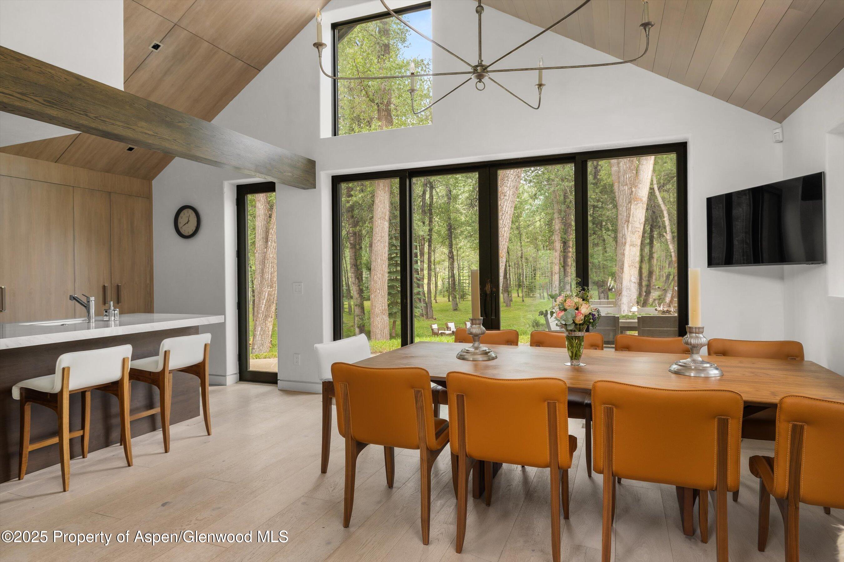 6458 Snowmass Creek Road Snowmass, CO 81654 - Photo 43 of 114 a view of a dining room with furniture window and outside view